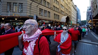 SYDNEY, AUSTRALIA - JUNE 08: Demonstrators carry a long piece of red fabric while marching along Market Street during a Pro-Palestine protest for Gaza on June 08, 2025 in Sydney, Australia. Organisers called on participants to wear the colour red to form a 'red line of humanity' while marching through the central business district (CBD). They are calling on the Australian Government to place sanctions on Israel. Picture: Lisa Maree Williams
