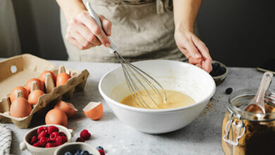 Picture shows a woman preparing cake batter. Cake mixes can teach us about AI, one speaker at EduTECH 2025 said.